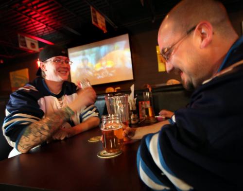 Steve Wilson (left) and buddy Dave Gowler share a microbrew at LuxaLune Wednesday evening watching a little hockey on the big screen. See story. May 1, 2013 - (Phil Hossack / Winnipeg Free Press)