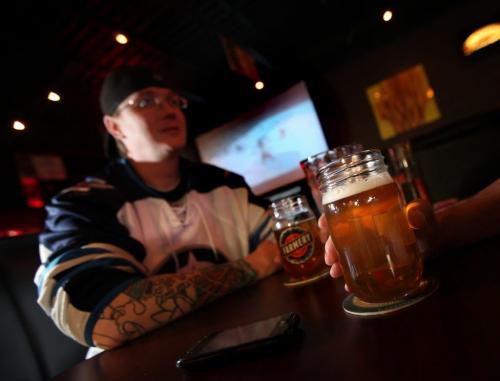 Steve Wilsonenjoys a microbrew at LuxaLune with friends Wednesday evening watching a little hockey on the big screen. See story. May 1, 2013 - (Phil Hossack / Winnipeg Free Press)