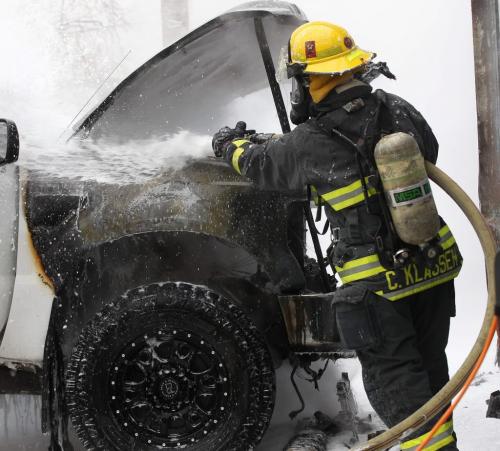 Firefighters extinguish a fire in a truck that erupted near 1PM at the rear of the Osborne Village Inn Thursday afternoon- The fire was quickly brought under control not before the truck was totaled- May 02, 2013   (JOE BRYKSA / WINNIPEG FREE PRESS)