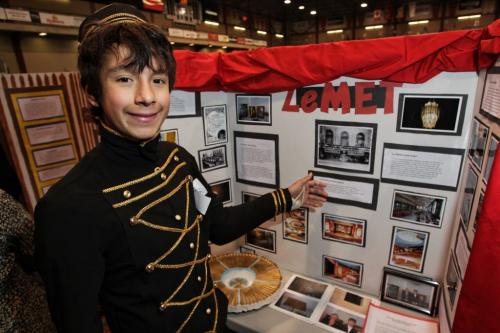 Jacob Sanchez a grade six student from Ecole La V¾©rendre school at his display called Le Metropolitan during the Red River Heritage Fair at the University of Winnipeg on Thursday. He is wearing an usher uniform styled on the type that would have been worn during the theatre's heyday.  130502 May 02, 2013 Mike Deal / Winnipeg Free Press