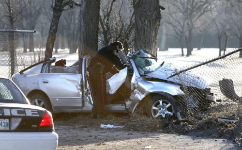 Winnipeg Police at the crash scene Friday morning on north Main St. after a  vehicle crossed the sidewalk, went through the chain link fence of the Kildonan Park Golf Course  and hit a  tree. It is unknown the extent of injuries.  Wayne Glowacki / Winnipeg Free Press May 3 2013