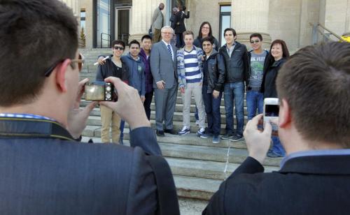 STANDUP- Some of Greg Selinger's crew help cature the moment for some exchange students from Miles Macdonell Collegiate on the front steps of the leg. May 3, 2013  BORIS MINKEVICH / WINNIPEG FREE PRESS