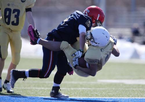 Jake Richardson of Team East tackles Melesse Eyob of Team West into the end zone late in the first half of the 28th Annual Blue and Gold Classic at East Side Eagles Field, Saturday, May 4, 2013. (TREVOR HAGAN/WINNIPEG FREE PRESS)