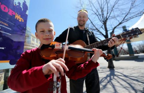 River Sawchyn, 10 and his father Stephen, shortly after getting their busking pass at The Forks, Saturday, May 4, 2013. River has been playing for 5 years, and it was his first time auditioning for a pass. (TREVOR HAGAN/WINNIPEG FREE PRESS)