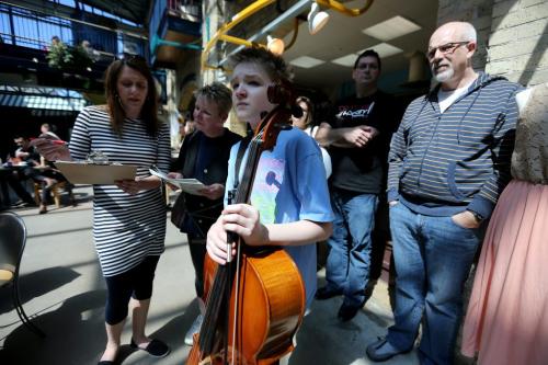 While his mother, Simone Karrasch takes care of paperwork, Joshua Orriss, 13, a cello player who has been playing for 6 years, waits to audition for his second busking pass at The Forks, Saturday, May 4, 2013. (TREVOR HAGAN/WINNIPEG FREE PRESS)