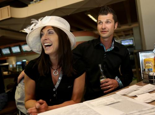 Sherry and Ryan Cote cheering during the 139th Kentucky Derby, watching from Assiniboia Downs, Saturday, May 4, 2013. (TREVOR HAGAN/WINNIPEG FREE PRESS)