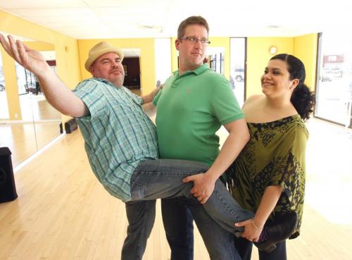 At left, Big Daddy Tazz and Derek Taylor pose for a picture with their Instructor Alicia Cascaval at Arthur Murray Dance Studio , they are taking part in the  Dancing With Celebrities, the SMD/Easter Seals ballroom competition that takes place Saturday night.  Doug Speirs story.(WAYNE GLOWACKI/WINNIPEG FREE PRESS) Winnipeg Free Press May 6 2013