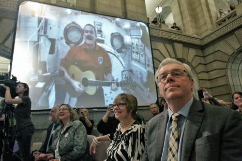 Premier Greg Selinger watches as students from schools across Winnipeg gather in the foyer of the Manitoba Legislative Building to perform during a live video feed of Commander Chris Hatfield who is on the International Space Station. Thousands of students from across the country are celebrating Music Month today by singing together via a live feed with Commander Hatfield.  130506 May 06, 2013 Mike Deal / Winnipeg Free Press