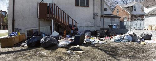 Garbage dumped in backyard of Aikins St. house . City of Winnipeg is cracking down on illegal dumping of garbage  with tougher new fines  , also reducing the number of derelict properties by one third .bart kives story  KEN GIGLIOTTI / May 6  2013 / WINNIPEG FREE PRESS
