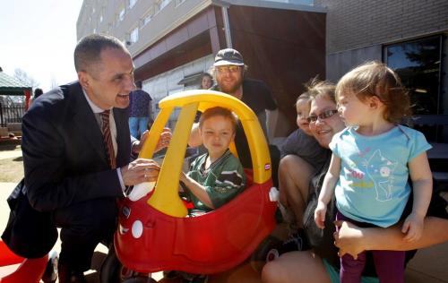At left, Kevin Chief, MLA for Point Douglas, Minister of Children and Youth Opportunities with Bernard Pollard and Rachel Thomas and their children Devin,4, in car, Jessica (right),1, and Nathan,2. The children are in the the Lord Selkirk Park Abecedarian project. Kevin Chief was interviewed regarding the EDC 5 year report to be released.  Alex Paul (WAYNE GLOWACKI/WINNIPEG FREE PRESS) Winnipeg Free Press May 6 2013