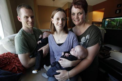 May 6, 2013 - 130506  - In their home Monday, May 6, 2013 husband and wife Mike Olson (L) and Lisa Seel (C) holding their sons Keenan and Kai respectively are photographed with Lisa's sister Averill Stephenson who was a surrogate for them. The province recognizes Stephenson and her husband as the parents and not Mike and Lisa. John Woods / Winnipeg Free Press