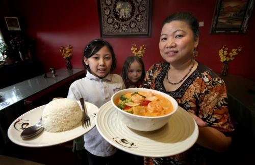 Left to right, Sommerlyn (10), Katana (5) and their grandmother Khamlaa Boonthajit show off a bowl of Gang Pet Curry and a side of rice at Lao-Thai. See Review. May 7, 2013 - (Phil Hossack / Winnipeg Free Press)