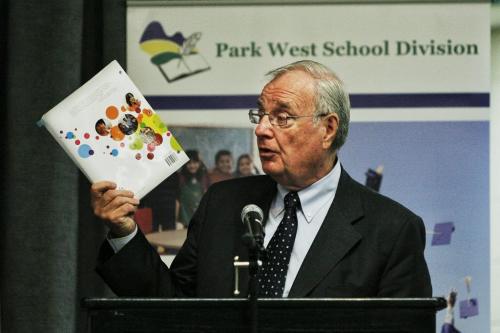 Former Prime Minister Paul Martin holds up a copy of the student/teacher resource book for the Martin Aboriginal Education Initiative class during a presentation at Major Pratt School in Russell, Manitoba.  130508 May 08, 2013 Mike Deal / Winnipeg Free Press