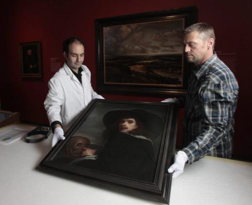 At left, Radovan Radulovic, Head Conservator at the WAG and Dan Donaldson, Gallery Technician at WAG take the painting titled SELF-PORTRAIT WITH SKULL by Flemish painter Michiel Sweerts out of the packing crate before it is hung at the media event Thursday for the WAG 100 Masters exhibit in the Winnipeg Art Gallery.  Carolin Vesely story  (WAYNE GLOWACKI/WINNIPEG FREE PRESS) Winnipeg Free Press May 9 2013