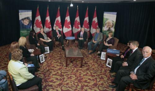 Prime Minister Stephen Harper (centre left)  attending a round table meeting on cyberbulling that included family of victims of cyberbulling  held in the Delta Inn in Winnipeg Friday. Larry Kusch story Wayne Glowacki/Winnipeg Free Press May 10 2013