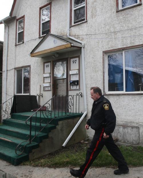 Winnipeg Police Service member outside a rooming house- late Friday afternoon in the 100 block of Lorne Ave where investigators found the remains of 36 year old Myrna Letandre- the death is now being treated as a homicide -See Mike McIntyre story- May 10, 2013   (JOE BRYKSA / WINNIPEG FREE PRESS)