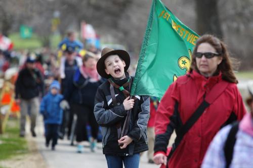 Eleven year old boy scout Alexander Burke holds walks with a flag as he makes his way into Assiniboine Park with a large group of scouts for the a National Scout day. . A 16 km hike with flags, youths between the ages of 5 to 26 and their leaders, in full uniform. Jamboree On The Trail (JOTT) is a first for Winnipeg but the 16th in Canada. Standup photo  May 11 2013,  Ruth Bonneville Winnipeg Free Press