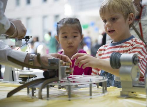 Saturday May 11 2013 - Winnipeg - DAVID LIPNOWSKI / WINNIPEG FREE PRESS  Six year old Ryan Davidson (right) learns about physics during the Science Rendevouz at the University of Manitoba EITC building Saturday afternoon. The event is a touring showcase of highly interaction science activities that included: a chemistry magic show, physics circus, and silmy surprises.