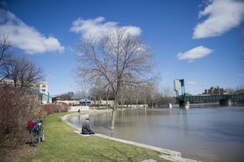 Saturday May 11 2013 - Winnipeg - DAVID LIPNOWSKI / WINNIPEG FREE PRESS  A man fishes on the flooded Assiniboine River at The Forks Saturday afternoon.   *Editors note: I asked if he minded if I took photos and he said 'no'. I took that I could take photos. I also asked if I could have his name, and he said 'no', I then asked if I could take some photos from behind that didn't identify him, and again he responded 'no'. Don't know if we can use them?