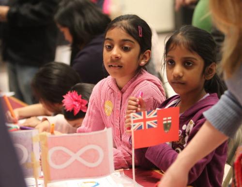 Eight year old Falisha Khan (pink) and her little sister Alyssa - six ,learn about Manitoba while attending Manitoba Day, a special birthdayi celebration n honour of our province's 143 Birthday which took place at the Manitoba Museum Saturday and was a free event for all Manitoban's.  May 11 2013,  Ruth Bonneville Winnipeg Free Press
