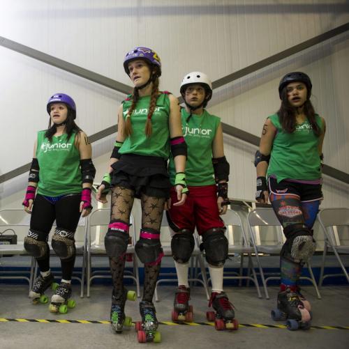 Saturday May 11 2013 - Winnipeg - DAVID LIPNOWSKI / WINNIPEG FREE PRESS JamRocks (green) (L-R) players Come At Me Bro( Ariana), Red Raign (Montana Patrick), Hackem Harley (Harley), and M.O. (Mary Anderson) before their Rollerderby bout against The Lost Girls (blue) at the Fort Garry Curling Club Saturday night.