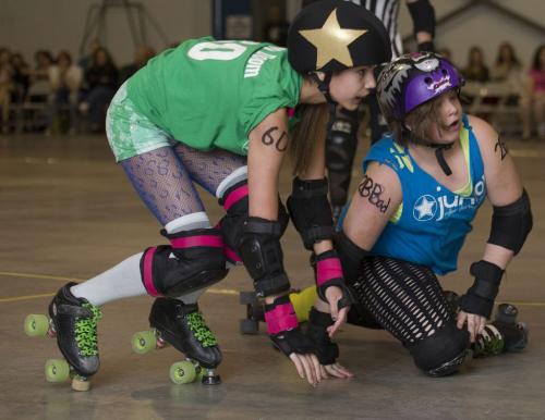 Saturday May 11 2013 - Winnipeg - DAVID LIPNOWSKI / WINNIPEG FREE PRESS Dolly Doom (Riley) of JamRocks (left) & Chuckie Bruister (Aaliyah Nelson) of the Lost Girls fall during their Rollerderby bout at the Fort Garry Curling Club Saturday night.
