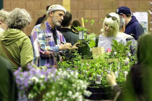 Volunteer Ray Normandeau (left) talks to Candace Borger (right) about plants during the annual Mother's Day Plant Sale at the CMU Shaftesbury campus.  130512 May 12, 2013 Mike Deal / Winnipeg Free Press