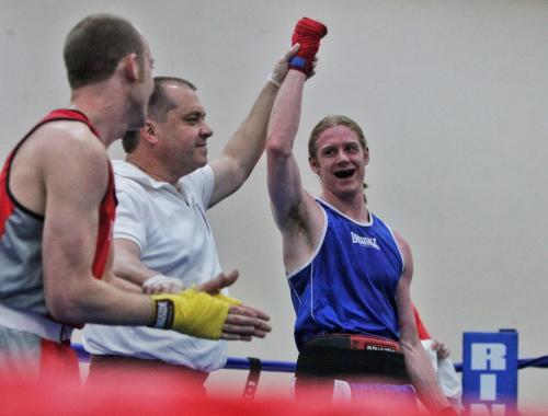 Adam Jacobsen in blue from the Pan Am Boxing Club celebrates a win against Jack Wiebe in red from the YFC Morris Boxing Club in a bout during the 2013 Manitoba Amateur Boxing Provincials at the Broadway Community Centre Sunday. 130512 May 12, 2013 Mike Deal / Winnipeg Free Press