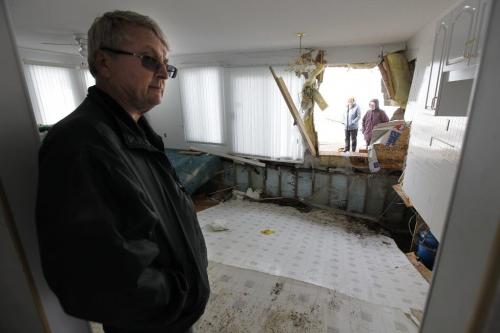 May 12, 2013 - 130512  -  On Sunday May 12, 2013 after clearing snow piled to the roof with his sons, Lorne Perche and his wife look the destruction at his cottage on Ochre Beach caused when lake ice was blown ashore by strong winds Friday, May 10, 2013. John Woods / Winnipeg Free Press