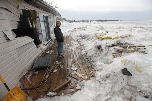 May 12, 2013 - 130512  -  On Sunday May 12, 2013 after clearing snow piled to the roof with his sons, Lorne Perche looks the destruction at his cottage on Ochre Beach caused when lake ice was blown ashore by strong winds Friday, May 10, 2013. John Woods / Winnipeg Free Press