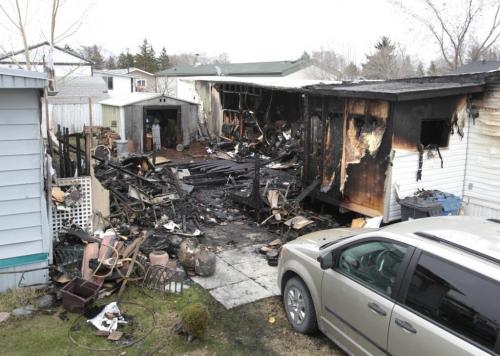 Two homes were heavily damaged by an overnight fire in the Downs Village mobile home community near the Perimeter Hwy. Monday morning. Wayne Glowacki/Winnipeg Free Press May 13 2013
