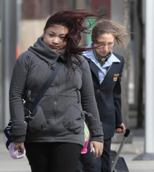 With the gusty winds, it was not a good hair day if you are a pedestrian on Portage Ave. Monday morning. Wayne Glowacki / Winnipeg Free Press May 13 2013