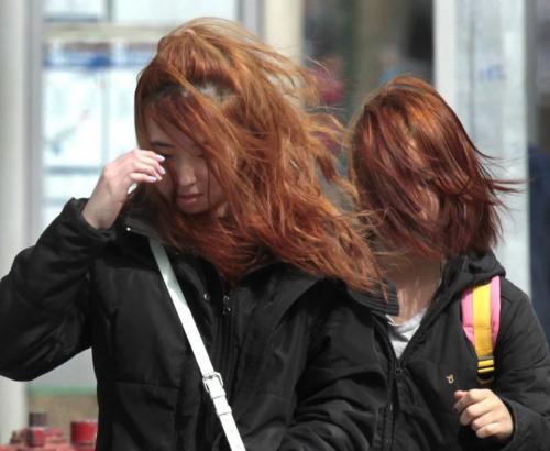 With the gusty winds, it was not a good hair day if you are a pedestrian on Portage Ave. Monday morning. Wayne Glowacki / Winnipeg Free Press May 13 2013