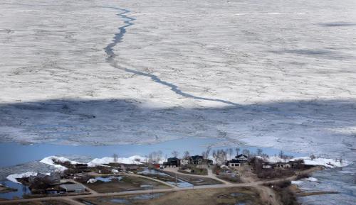 Ice pushes up against and pile up alongside homes in the community of Ochre Beach SouthEast of Dauphin Mb. Ice on Lake Dauphin (top) threatens to blow back onshore and do further damage Monday. See story. May 13, 2013 - (Phil Hossack / Winnipeg Free Press)