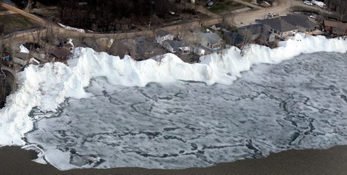 Ice pushes up against and pile up alongside homes in the community of Ochre Beach SouthEast of Dauphin Mb. Ice on Lake Dauphin (top) threatens to blow back onshore and do further damage Monday. See story. May 13, 2013 - (Phil Hossack / Winnipeg Free Press)