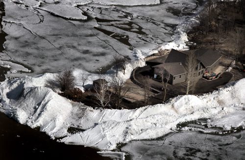 Ice threatens a home on a point of land in the community of Ochre Beach SouthEast of Dauphin Mb. Ice on Lake Dauphin threatens to blow back onshore and do further damage Monday. See story. May 13, 2013 - (Phil Hossack / Winnipeg Free Press)
