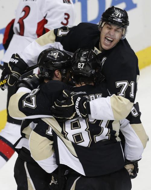 Pittsburgh Penguins' Evgeni Malkin (R) celebrates a goal by teammate Chris Kunitz (L) and Sidney Crosby against the Ottawa Senators during the first period of Game 1 of their NHL Eastern Conference semi-final hockey game in Pittsburgh, Pennsylvania May 14, 2013. REUTERS/Jason Cohn (UNITED STATES  - Tags: SPORT ICE HOCKEY)   - RTXZMR7
