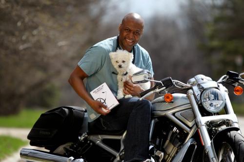Donovan Gray MD sits on his new motorcycle with his dog "Steth" and his book "Dude where's my stethoscope and other stories from ER" - See Carolin Vesely's story.  Photography by Ruth Bonneville Winnipeg Free Press