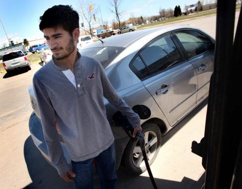 19 yr old Harman Bhamrah (19) a student puts $20.00 of regular in his car. He says he can't afford to fill his tank much anymore. Gas price hike, just before another long weekend......See Murray McNeil's story. May 15, 2013 - (Phil Hossack / Winnipeg Free Press)