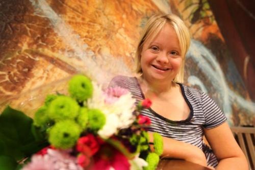 Lauren Potter, star of tv show "Glee"  in Winnipeg for national down syndrome conference, takes a moment for photographs with fans and press at the Delta Hotel Saturday morning as she holds flowers from one of her fans from the audience. May 18, 2013 Ruth Bonneville Winnipeg Free Press