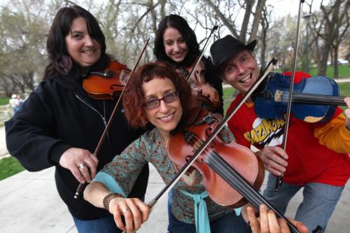 Local fiddlers have some fun fiddling under  the canopy at Coronation Park Saturday afternoon for the 1st annual World Fiddle Day.  Names from left Patti Lamoureux, Emilie Chartier,, Larry Martineau and Miriam Neuman (front)  Standup photo  May 18, 2013 Ruth Bonneville Winnipeg Free Press