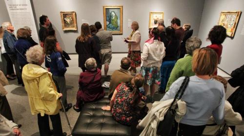 The Winnipeg Art Gallery is packed this rainy Victoria Day weekend as art lovers took the opportunity to visit the recently opened gallery titled, 100 Masters: Only in Canada.  A tour guide talks and answers questions about Pablo Picasso's painting La Mis¾©reuse Accroupie (The Crouching Beggar), centre, while dozens of visitors look on.  The show includs the works of major paintings by Rembrandt van Rijn, Giovanni Paolo Panini, Claude Monet, Pierre-August Renoir, Vincent van Gogh, Pablo Picasso, Henri Matisse, Andy Warhol and many more. It will be open until August 18th. 130519 May 19, 2013 Mike Deal / Winnipeg Free Press