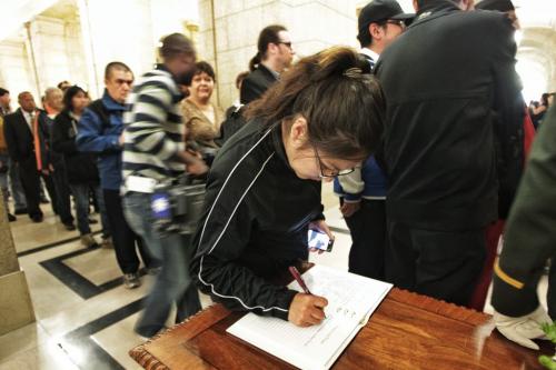 Tina Umpherville signs a book of condolences while waiting along with hundreds of mourners who lined up to pay their final respects at the legislature where the body of Elijah Harper lay in state Monday afternoon.  130520 May 20, 2013 Mike Deal / Winnipeg Free Press