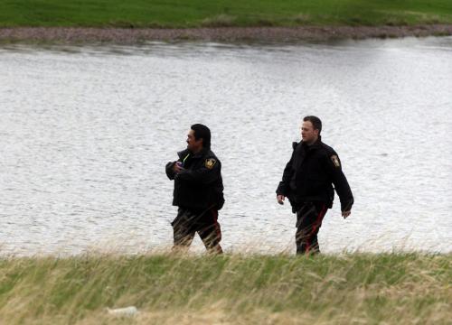 Wpg Fire take one body from a submerged car in a retention pond on Dalhousie Dr near Pembina , a red car with its trunk open is partially submerged  KEN GIGLIOTTI / May 21  2013 / WINNIPEG FREE PRESS