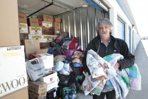 Ron Eldridge, a Director of Devoted To You Street Ministries holds blankets at the  storage locker containing donations (mostly clothing) for homeless. Kevin Rollason story (WAYNE GLOWACKI/WINNIPEG FREE PRESS) Winnipeg Free Press May 21 2013