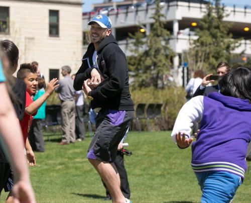 Blue Bombers QB Buck Pierce plays football with young students after it was announced he would be an adjunct coach with the University of Winnipeg and assist Dave Donaldson with his Inner City Youth Football Program. 130522 - Wednesday, May 22, 2013 - (Melissa Tait / Winnipeg Free Press)