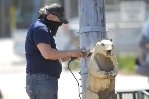 Dwayne Ball carves some animals on Sutherland in front of the Manitoba Indigenous Cultural Education Centre. The carvings were done by some other artists but he is refurbishing them and adding detail and finishing. May 22, 2013  BORIS MINKEVICH / WINNIPEG FREE PRESS