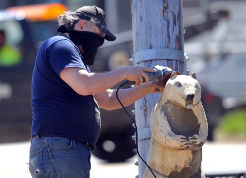 Dwayne Ball carves some animals on Sutherland in front of the Manitoba Indigenous Cultural Education Centre. The carvings were done by some other artists but he is refurbishing them and adding detail and finishing. May 22, 2013  BORIS MINKEVICH / WINNIPEG FREE PRESS