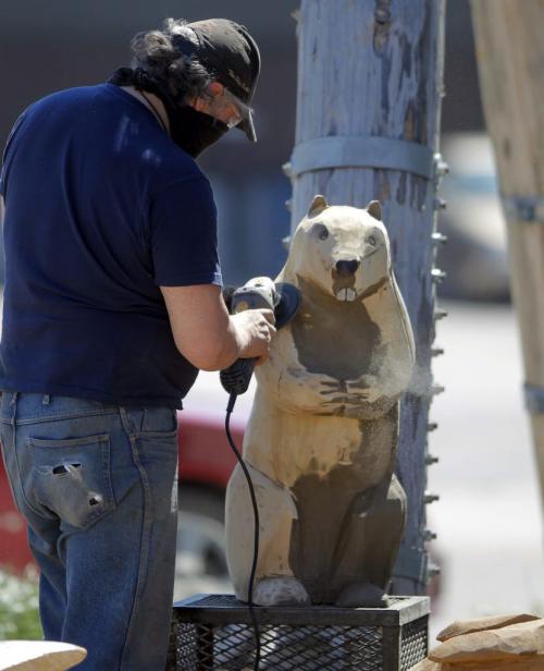 Dwayne Ball carves some animals on Sutherland in front of the Manitoba Indigenous Cultural Education Centre. The carvings were done by some other artists but he is refurbishing them and adding detail and finishing. May 22, 2013  BORIS MINKEVICH / WINNIPEG FREE PRESS