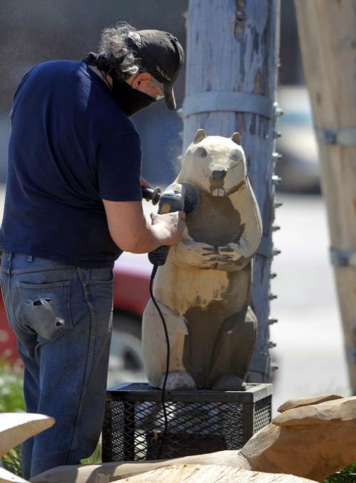 Dwayne Ball carves some animals on Sutherland in front of the Manitoba Indigenous Cultural Education Centre. The carvings were done by some other artists but he is refurbishing them and adding detail and finishing. May 22, 2013  BORIS MINKEVICH / WINNIPEG FREE PRESS